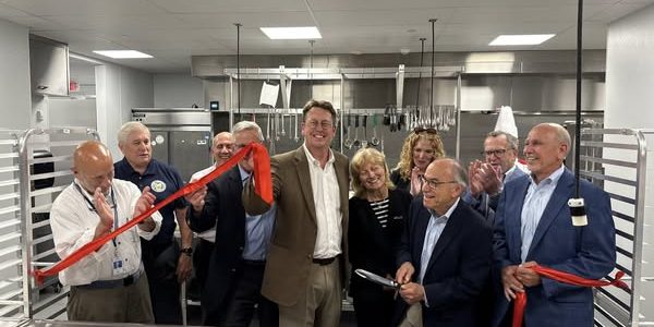 helping harvest kitchen ribbon cutting